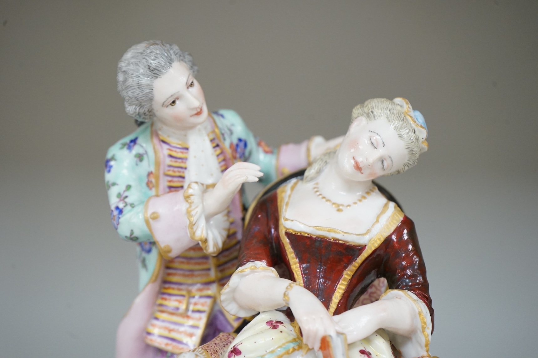 A German porcelain group of a seated sleeping beauty, 21cm high